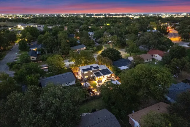 an aerial view of a house with a yard