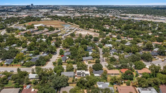 an aerial view of residential houses with outdoor space