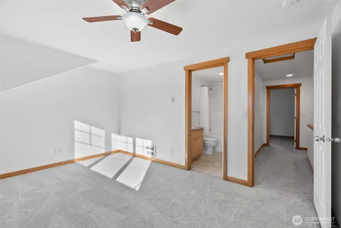 a view of a room with a ceiling fan