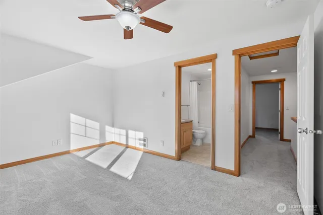 a view of a room with a ceiling fan