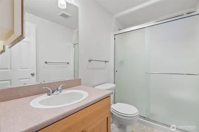 a bathroom with a sink toilet and a mirror