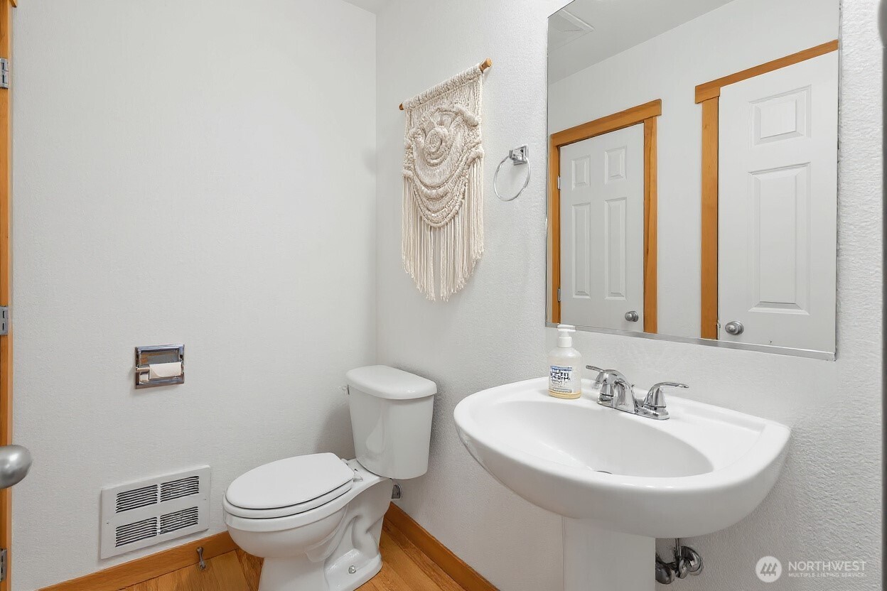 1322 Polly's Lane Bainbridge Island, WA 98110 - Photo 20 of 21 a bathroom with a sink a toilet and a mirror