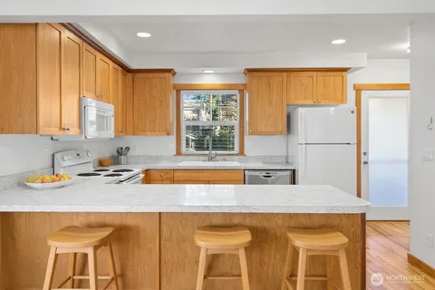 a kitchen with a sink a refrigerator and window