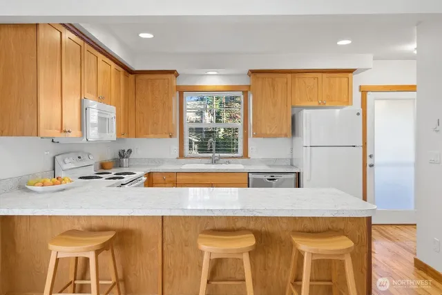 a kitchen with a sink a refrigerator and window