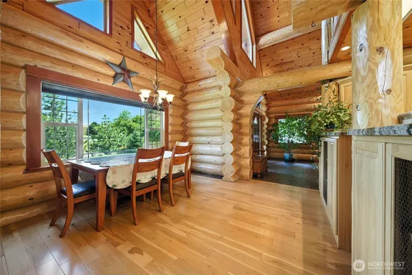 a view of a patio with table and chairs and wooden floor