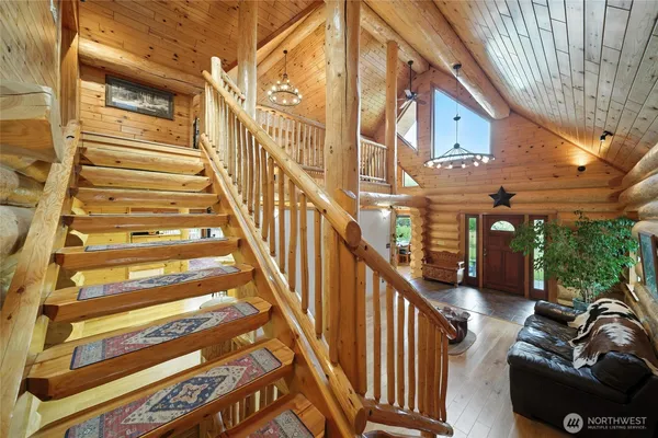 a view of staircase with lots of frames on wall and a window