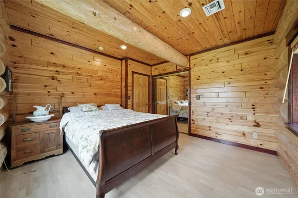 a spacious bedroom with a bed and a table