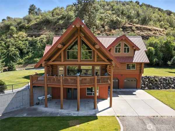 an aerial view of a house with a yard balcony