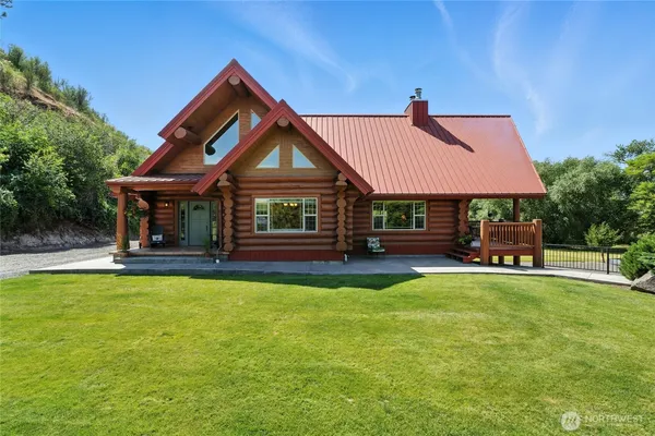 a view of a house with swimming pool and sitting area
