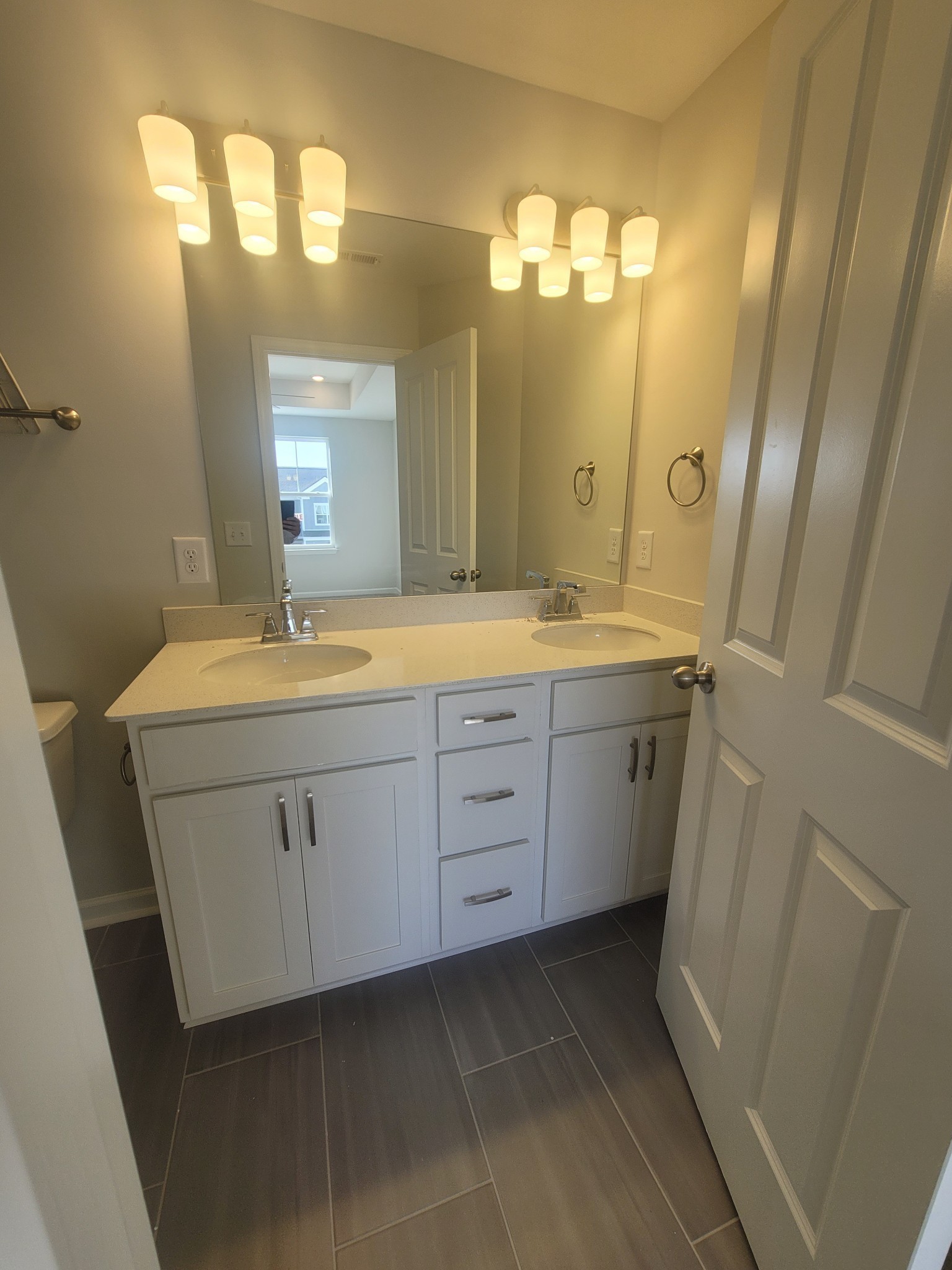 504 Gilroy Court Antioch, TN 37013 - Photo 6 of 17 a bathroom with a double vanity sink mirror and a shower