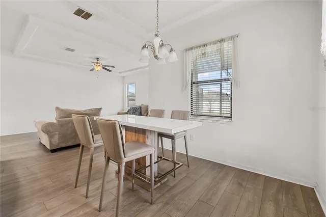 a view of a dining room with furniture window and wooden floor