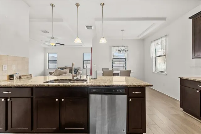 a kitchen with center island and stainless steel appliances
