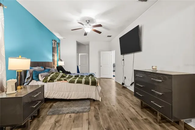 a bedroom with a bed and flat screen tv
