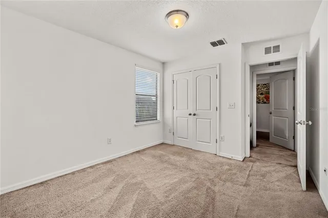 an empty room with closet area