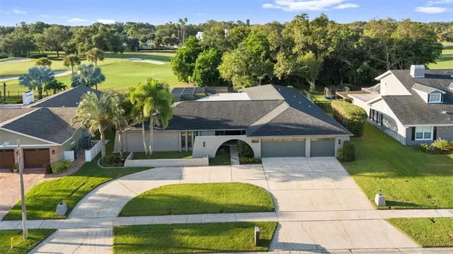 a view of a swimming pool with a patio and a yard