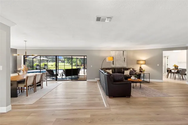 a spacious bedroom with a bed and glass door