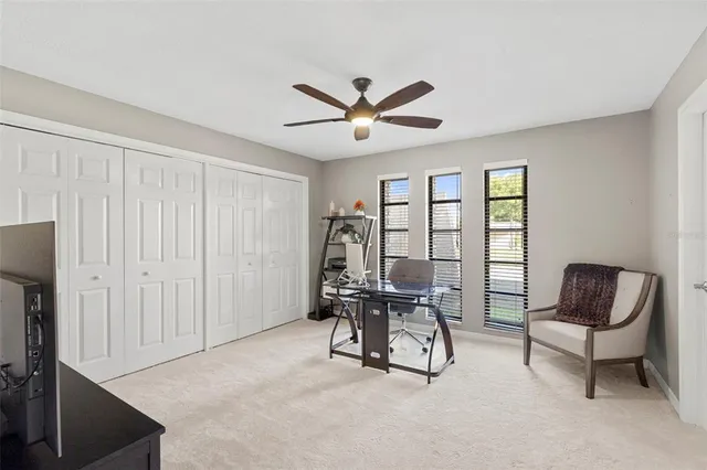 a living room with furniture and kitchen view