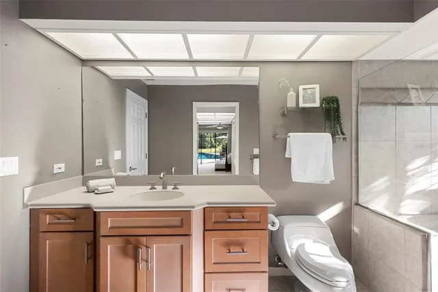 a living room with furniture a fireplace and a floor to ceiling window