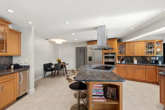 a bathroom with a toilet a sink and a large mirror