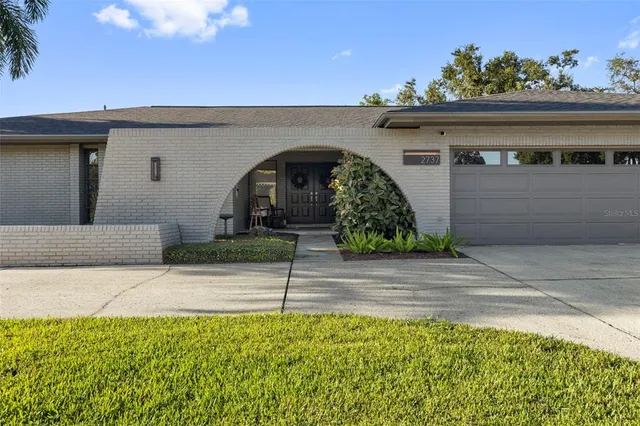 a front view of a house with outdoor seating