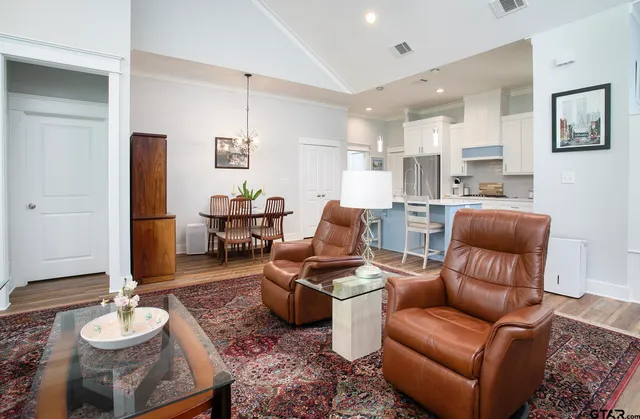 a living room with furniture and wooden floor