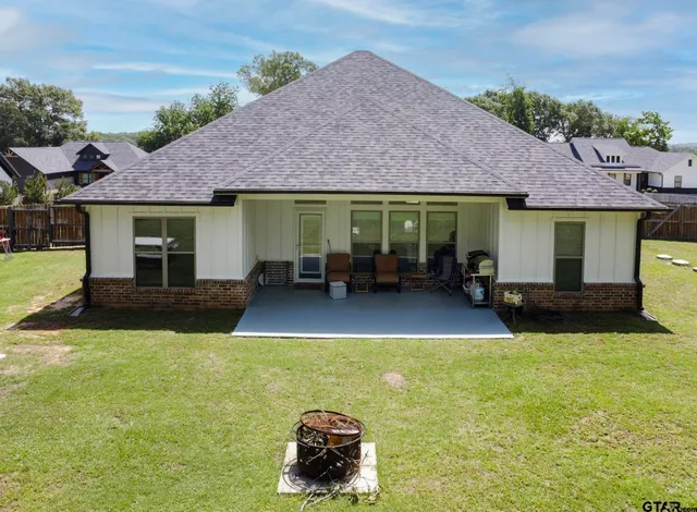 a swimming pool with patio outdoor seating and yard