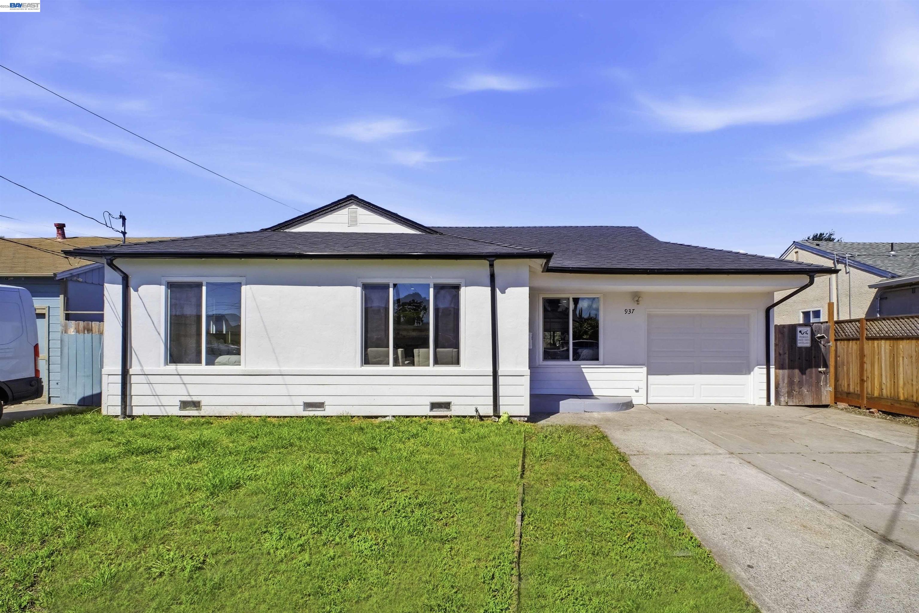 a front view of a house with a garden and yard