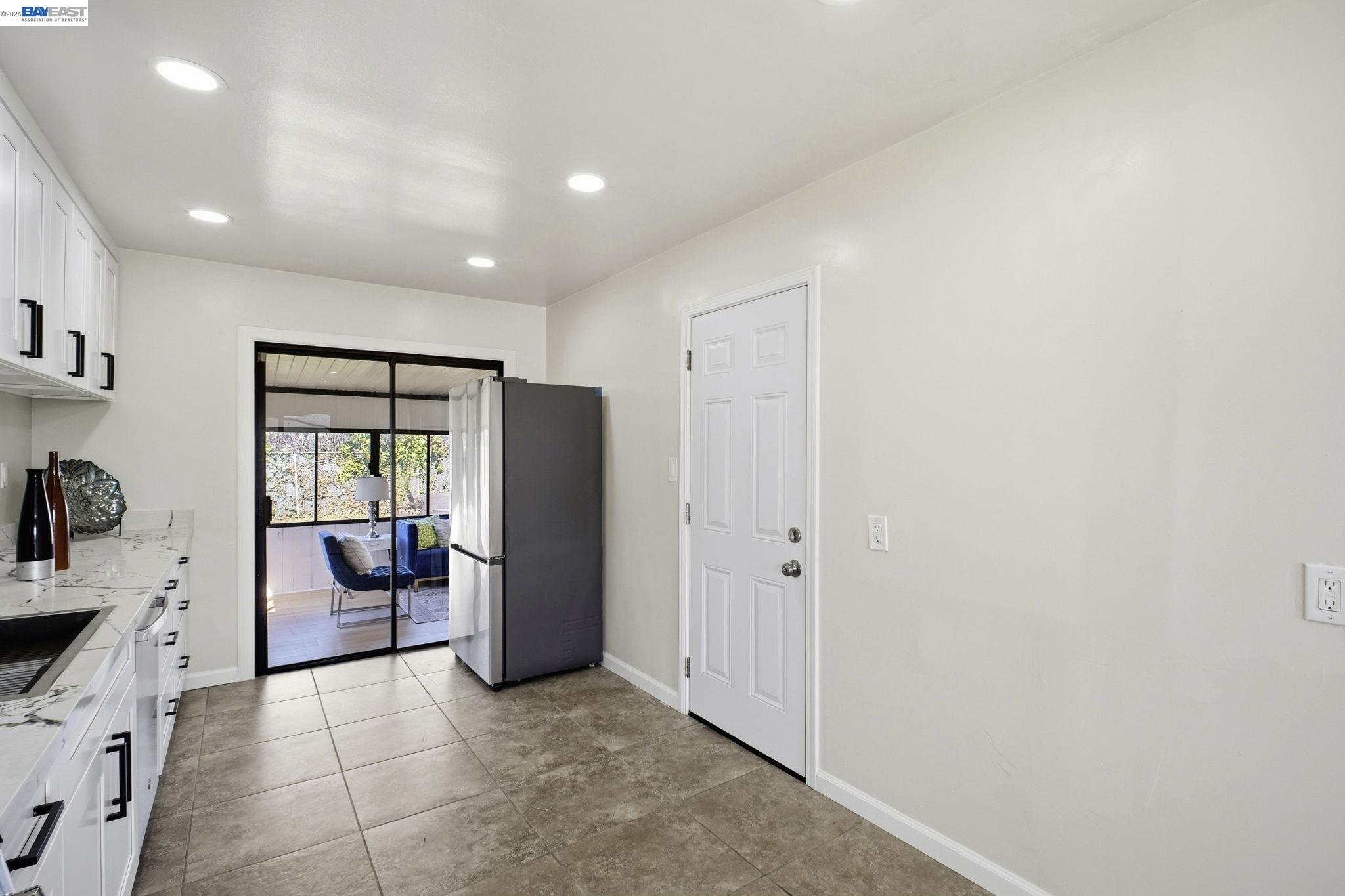 937 Neil Way Hayward, CA 94545 - Photo 14 of 37 a view of a kitchen with a sink and dishwasher a refrigerator with white cabinets