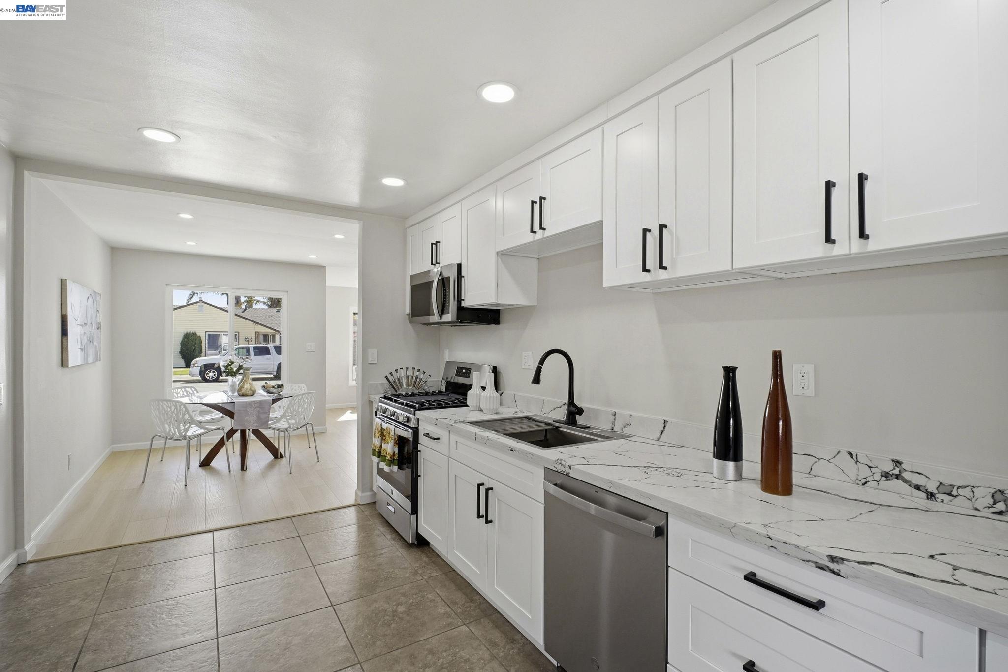 937 Neil Way Hayward, CA 94545 - Photo 15 of 37 a kitchen with a sink white cabinets and appliances