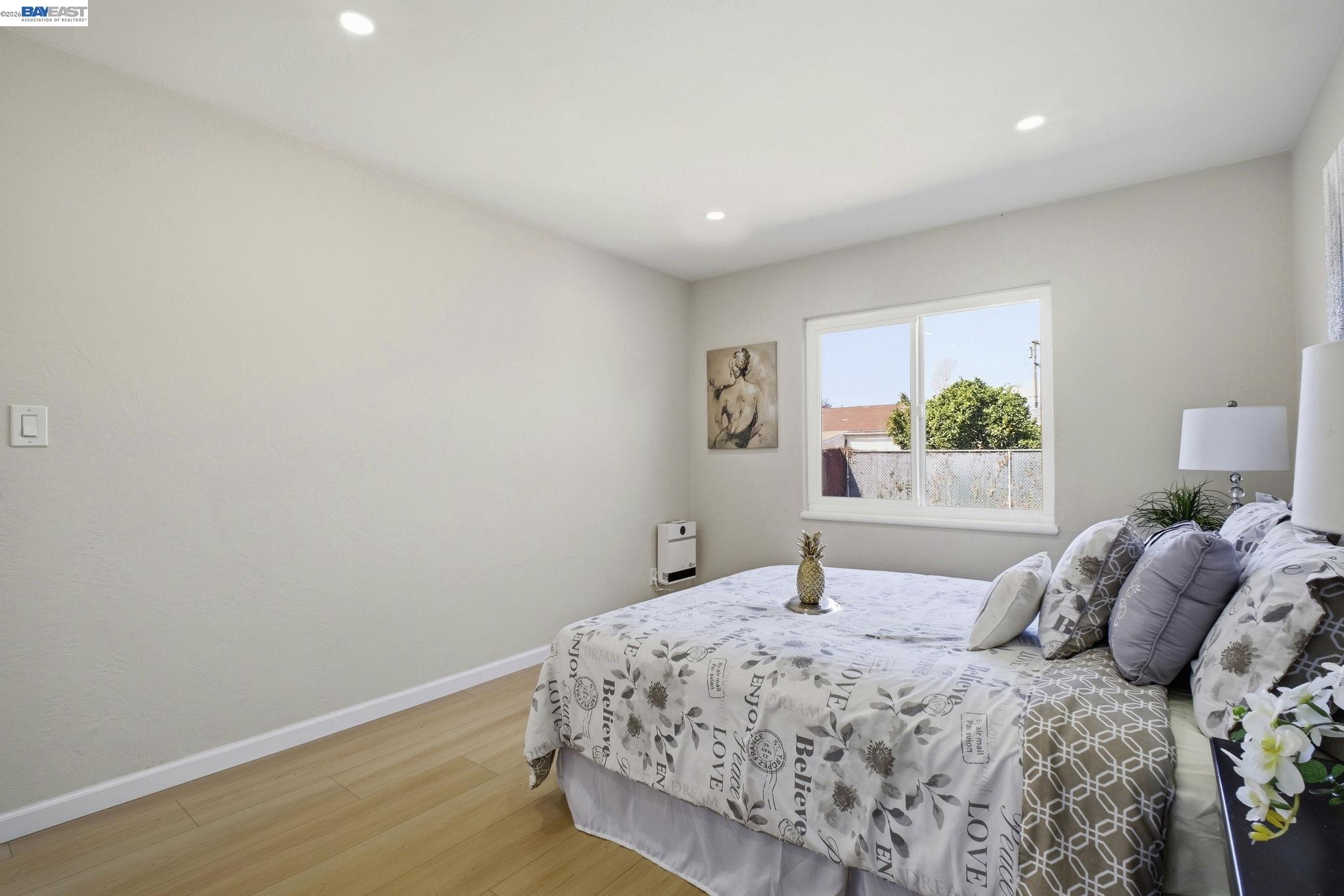 937 Neil Way Hayward, CA 94545 - Photo 23 of 37 a bedroom with a large bed and a window