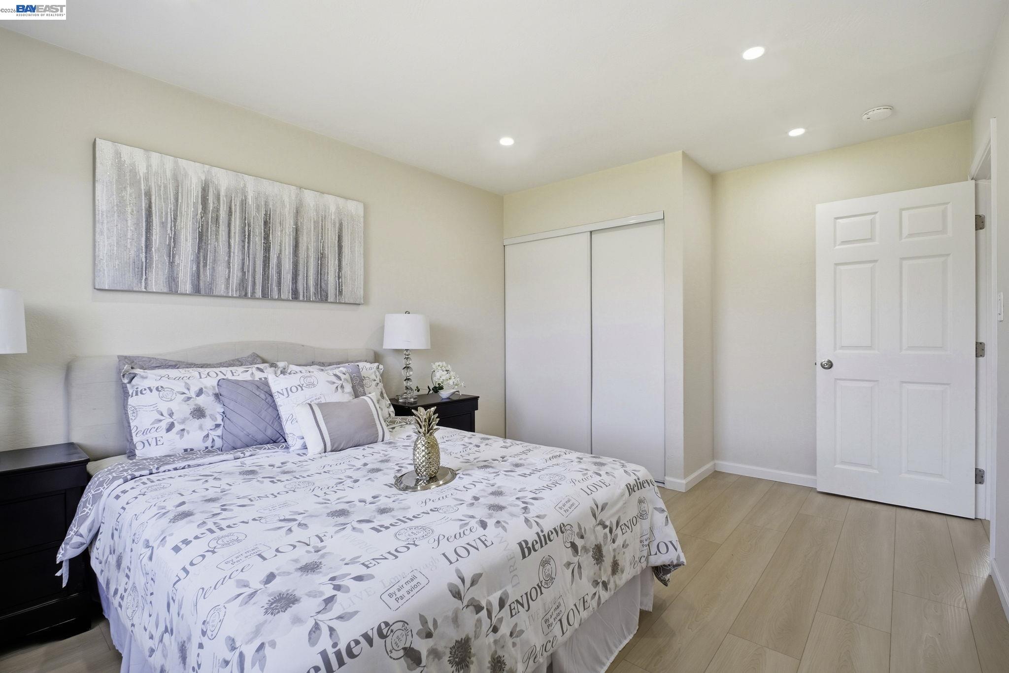 937 Neil Way Hayward, CA 94545 - Photo 24 of 37 a bedroom with a bed and a painting