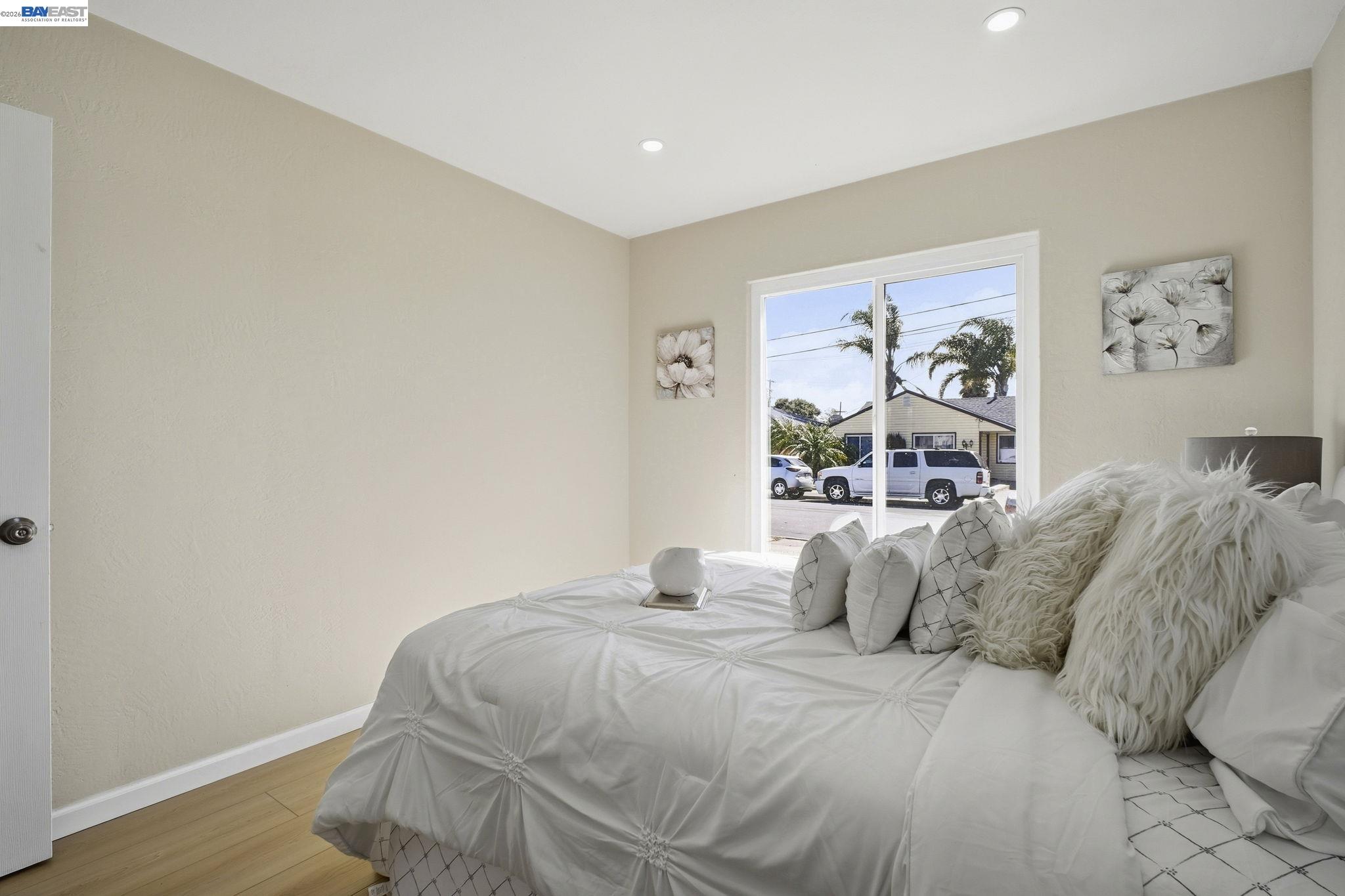 937 Neil Way Hayward, CA 94545 - Photo 28 of 37 a bedroom with a bed and painting on the wall