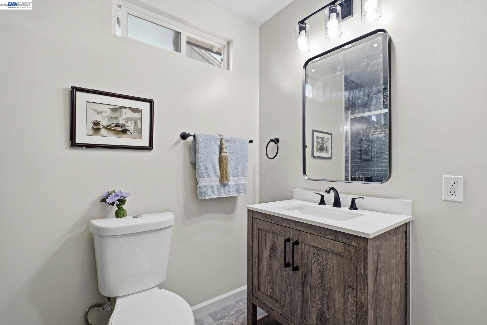 937 Neil Way Hayward, CA 94545 - Photo 30 of 37 a bathroom with a toilet sink and mirror