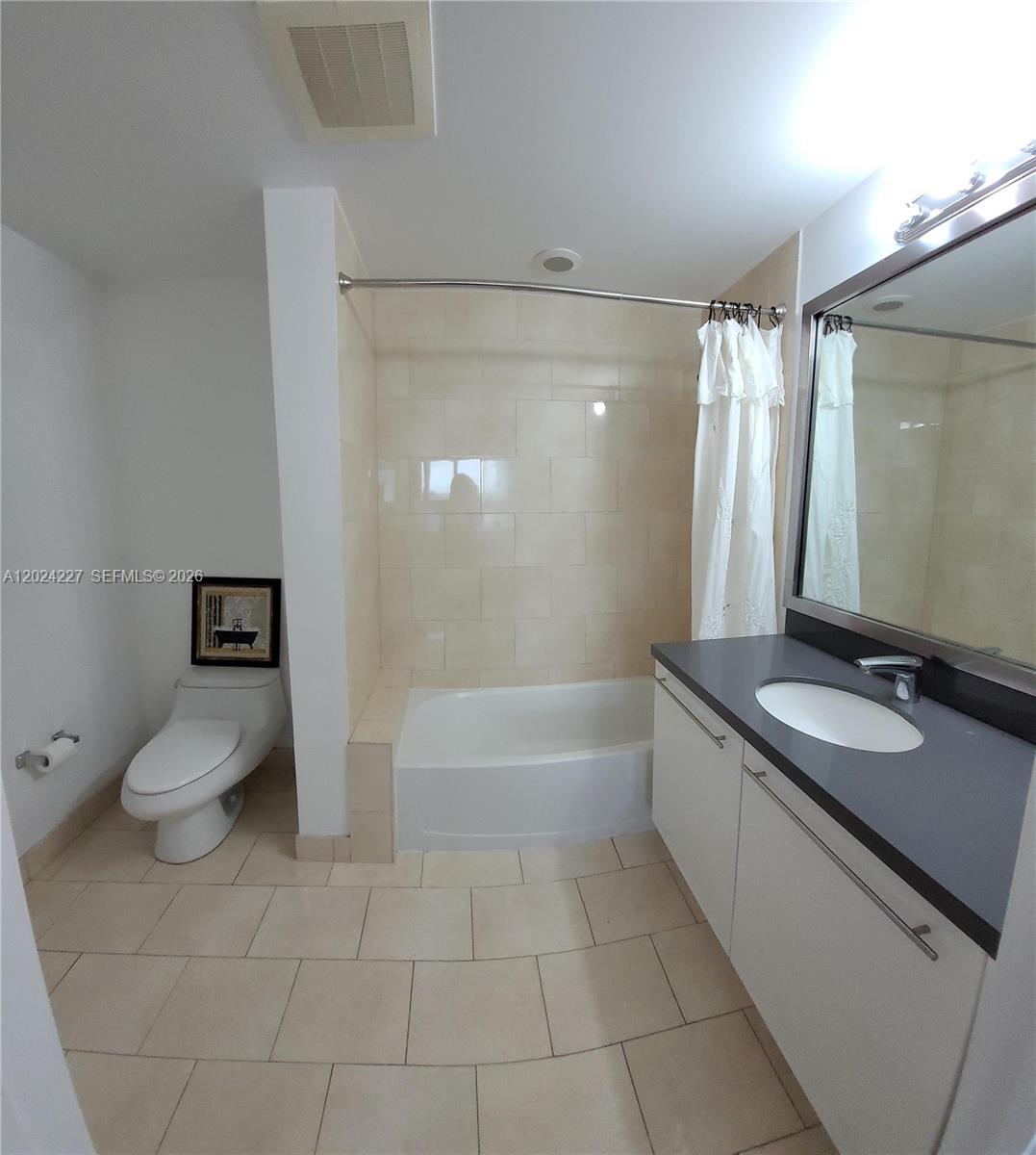 90 Southwest 3rd Street, Unit 2208 Miami, FL 33130 - Photo 23 of 56 a bathroom with a granite countertop sink a toilet and bathtub