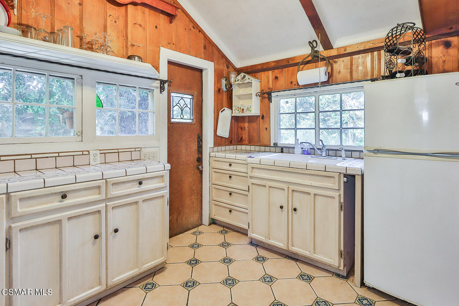 6456 Clear Springs Road Simi Valley, CA 93063 - Photo 19 of 56 a kitchen with white cabinets and window