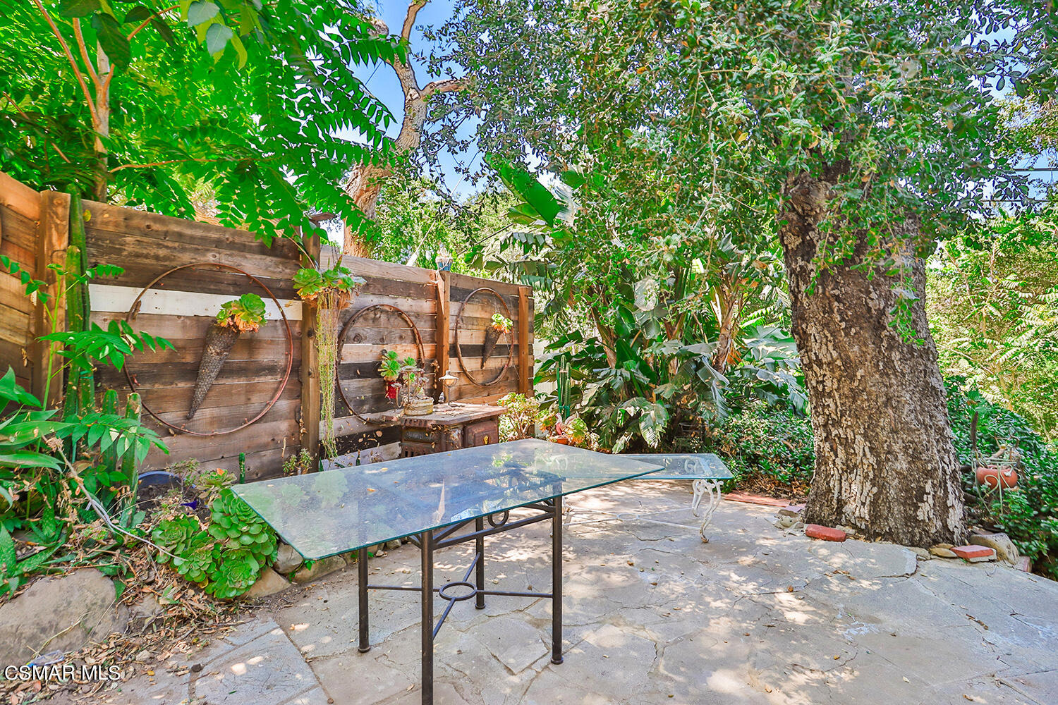 6456 Clear Springs Road Simi Valley, CA 93063 - Photo 33 of 56 a backyard of a house with large trees and outdoor seating
