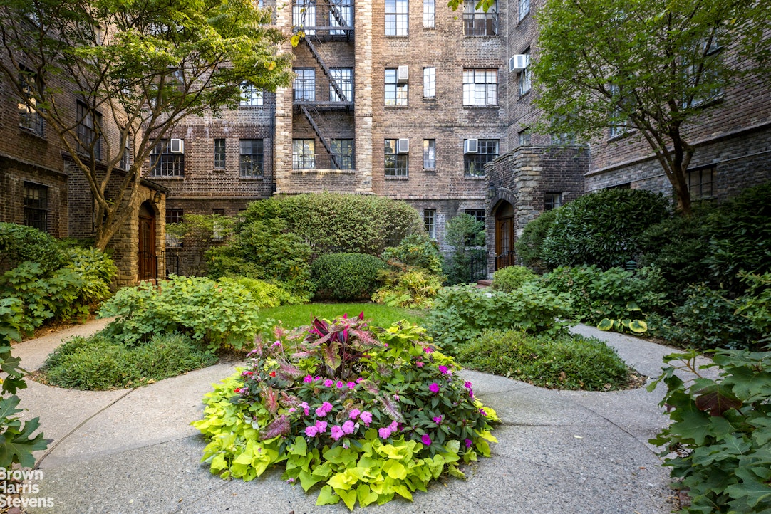 116 Pinehurst Avenue, Unit D11 Manhattan, NY 10033 - Photo 1 of 12 a house with a lot of flower plants and wooden fence