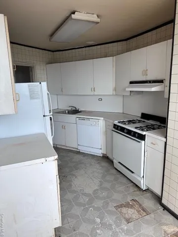 a kitchen with a stove a sink and a refrigerator