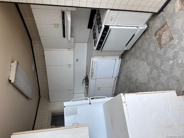 125-10 Queens Boulevard, Unit 2307 Queens, NY 11415 - Photo 11 of 25 a kitchen with a stove a sink and a refrigerator