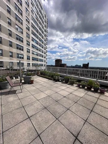 a terrace with outdoor seating and barbeque oven