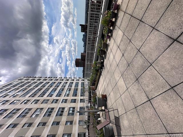 125-10 Queens Boulevard, Unit 2307 Queens, NY 11415 - Photo 22 of 25 a terrace with outdoor seating and barbeque oven