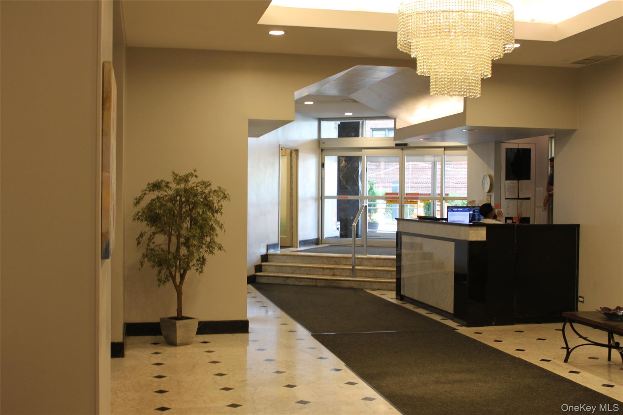125-10 Queens Boulevard, Unit 2307 Queens, NY 11415 - Photo 3 of 25 a kitchen with stainless steel appliances kitchen island granite countertop a refrigerator and a stove