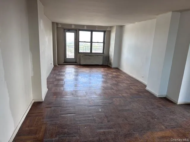 wooden floor in an empty room with a window