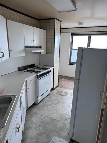 a kitchen with a stove a sink and a refrigerator