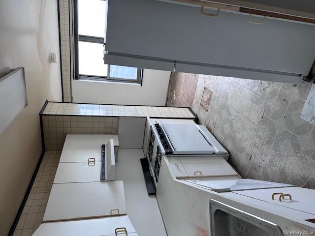 125-10 Queens Boulevard, Unit 2307 Queens, NY 11415 - Photo 10 of 25 a kitchen with a stove a sink and a refrigerator