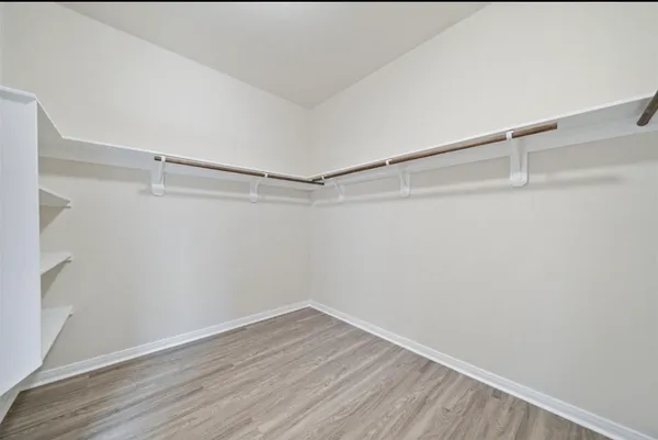 an empty room with a ceiling fan and a window