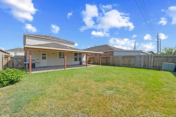 a view of a house with backyard and sitting area