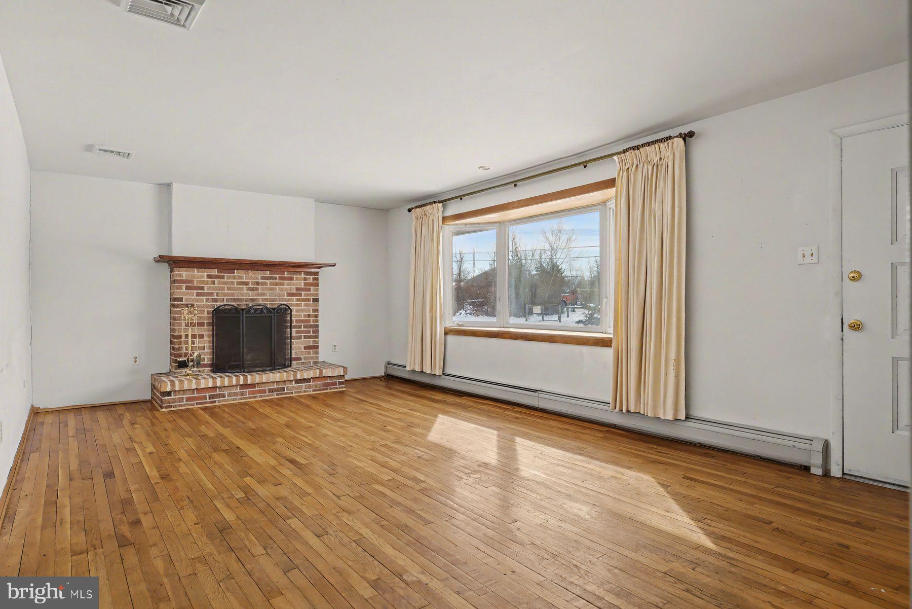 3702 Kings Road Pennsburg, PA 18073 - Photo 9 of 36 Sunny living room with brick fireplace