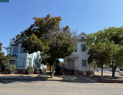 a front view of a house with a tree