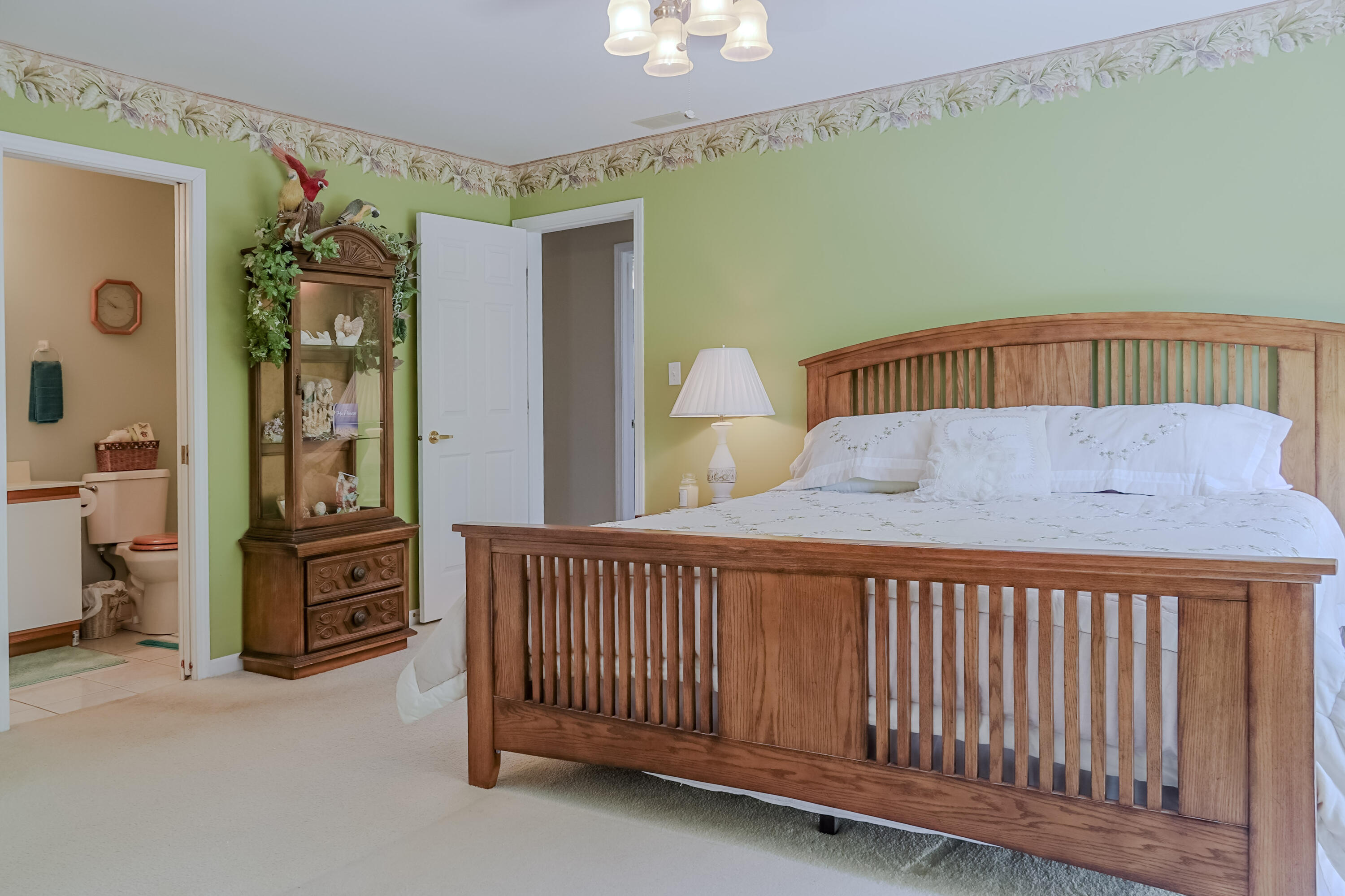 5065 Spinnaker Lane, Unit D Crown Point, IN 46307 - Photo 3 of 42 a bedroom with a bed and a chandelier